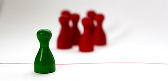 Green pawn facing group of red pawns across red line