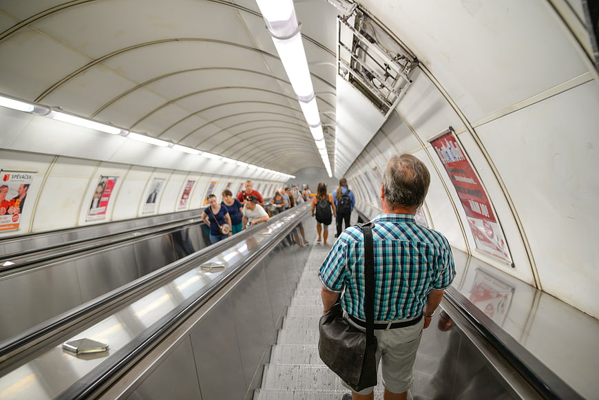 Man Riding Subway Escalator in Modern Underground Station