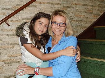 Mother and daughter hugging on stairs