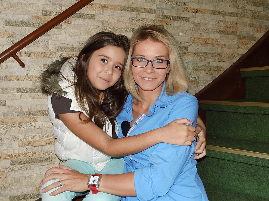 Mother and daughter hugging on stairs