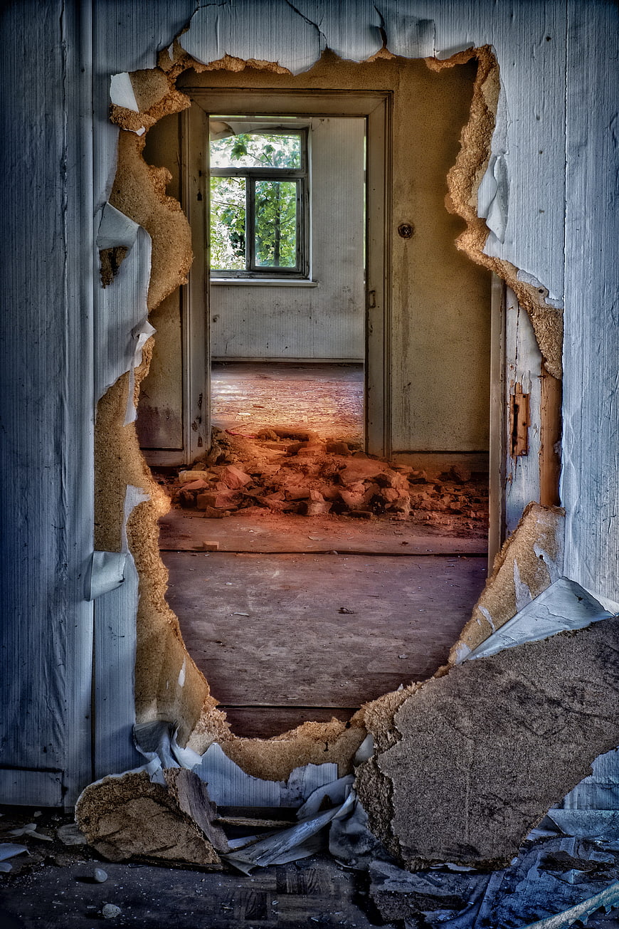 Broken Hole in Dilapidated Wall of Abandoned House Interior