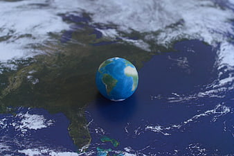Small Earth Globe Model on Satellite Map Background