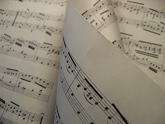 Close-up of sheet music with turning page