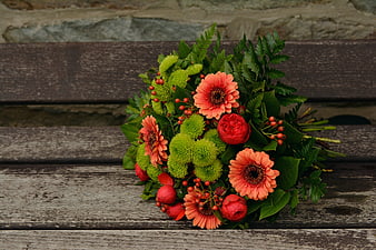 Vibrant autumn flower bouquet on rustic wooden bench
