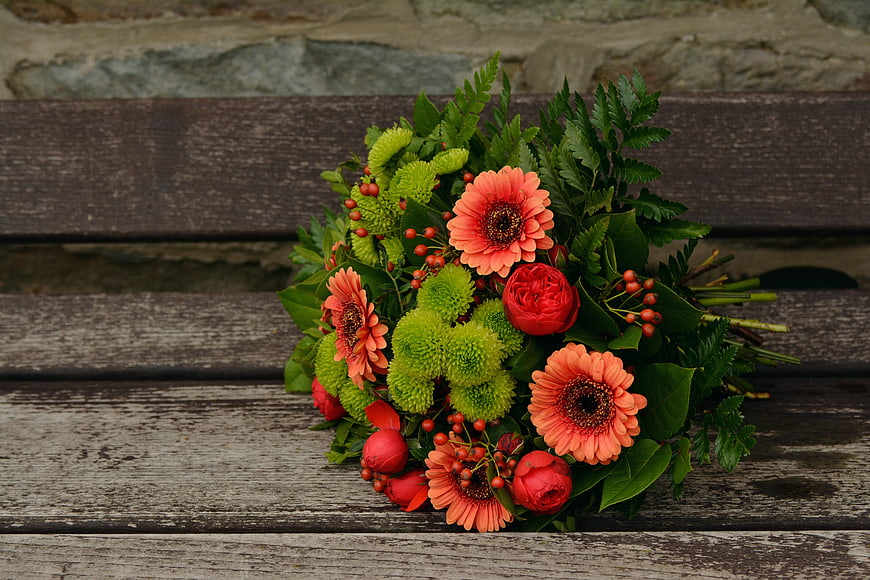 Vibrant autumn flower bouquet on rustic wooden bench