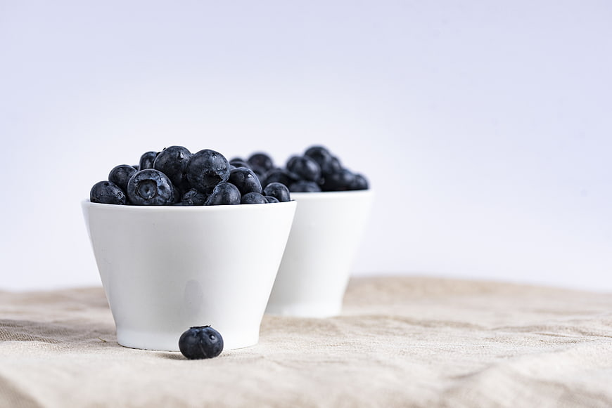 Fresh Blueberries in White Bowls on Linen