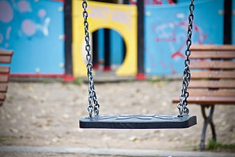 Empty Playground Swing With Colorful Graffiti Background