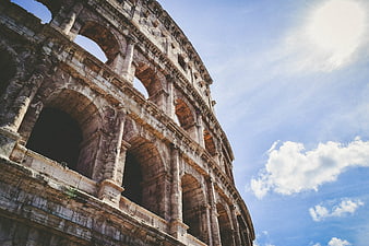Low angle view of the Colosseum in Rome against blue sky