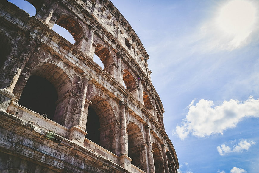 Low angle view of the Colosseum in Rome against blue sky