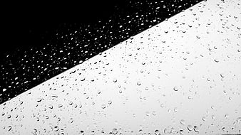 Black and white raindrops on glass with diagonal contrast