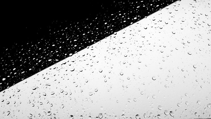 Black and white raindrops on glass with diagonal contrast