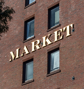 Golden Market Sign on Red Brick Building Facade