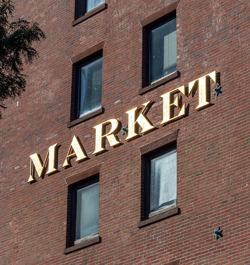 Golden Market Sign on Red Brick Building Facade