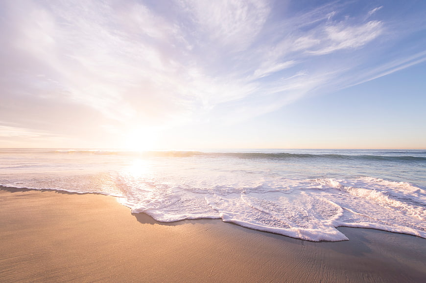 Serene Beach Sunrise with Gentle Waves and Golden Sand