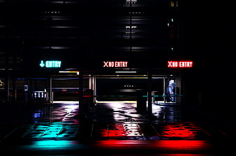 Neon Entry and No Entry Signs in Dark Parking Garage