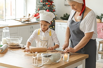 Grandmother and granddaughter baking Christmas cookies in kitchen