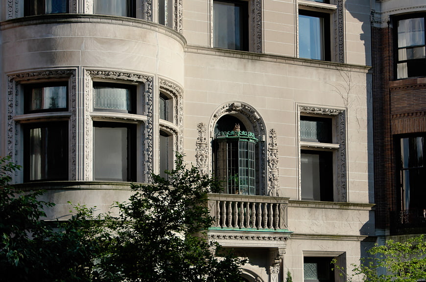 Ornate Beige Stone Building Facade with Balcony
