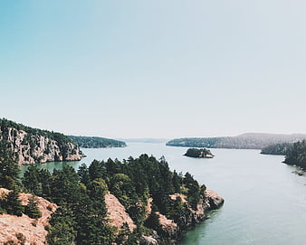 Scenic coastal landscape with rocky cliffs and calm blue water