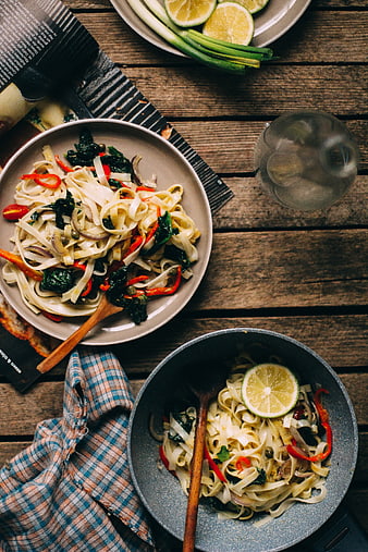 Top view of fresh Asian noodle dishes on rustic wooden table