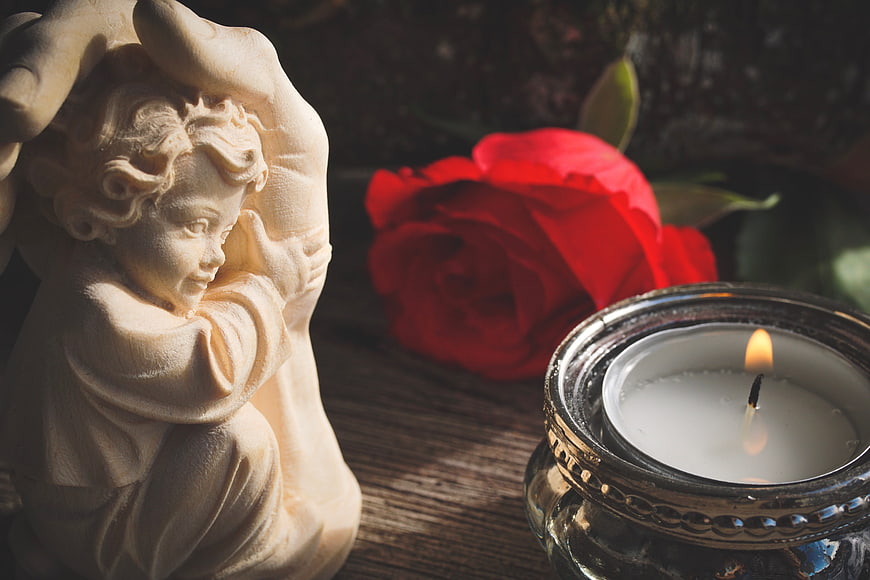 Religious Angel Statue With Red Rose And Candle