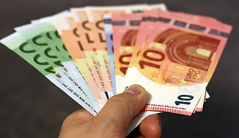 Hand Holding Fan of Euro Banknotes