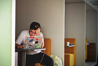 Stressed Developer Working on Laptop in Office Cubicle
