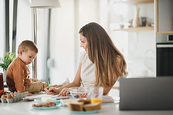 Mother and Toddler Eating Breakfast in Modern Kitchen