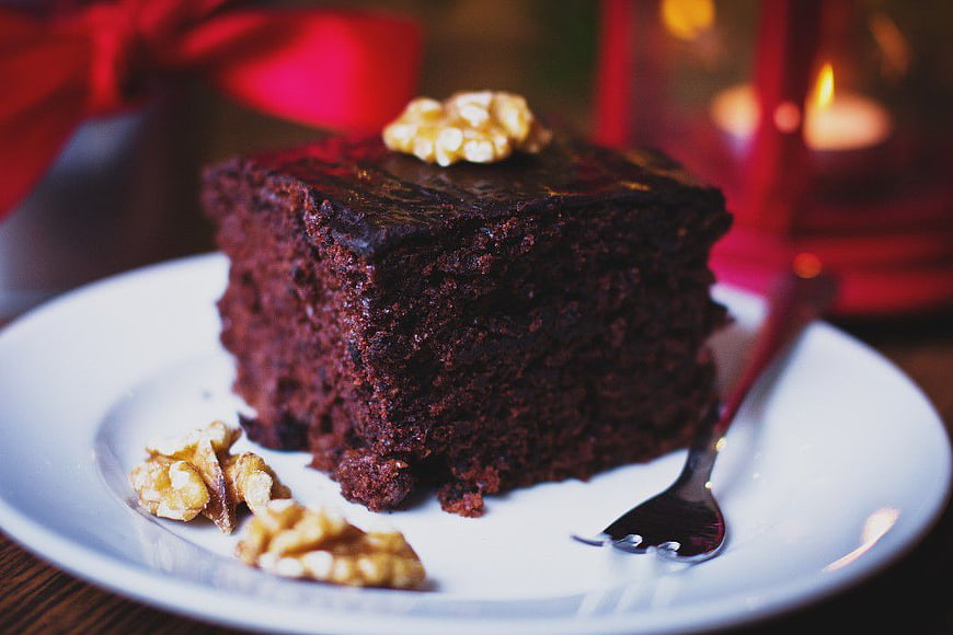 Rich Chocolate Cake Slice with Walnuts on White Plate