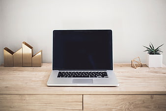 Minimalist Workspace with Laptop on Wooden Desk