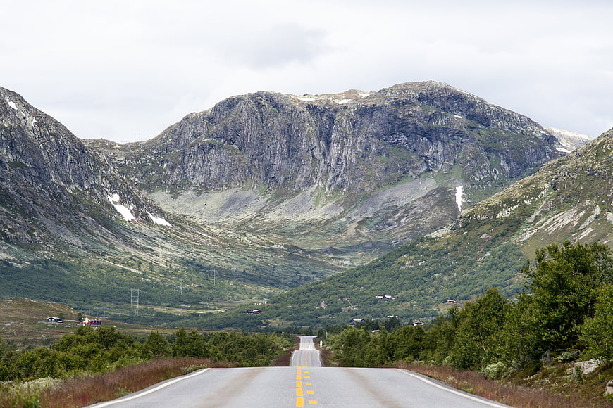Winding Mountain Road Leading to Rugged Peaks