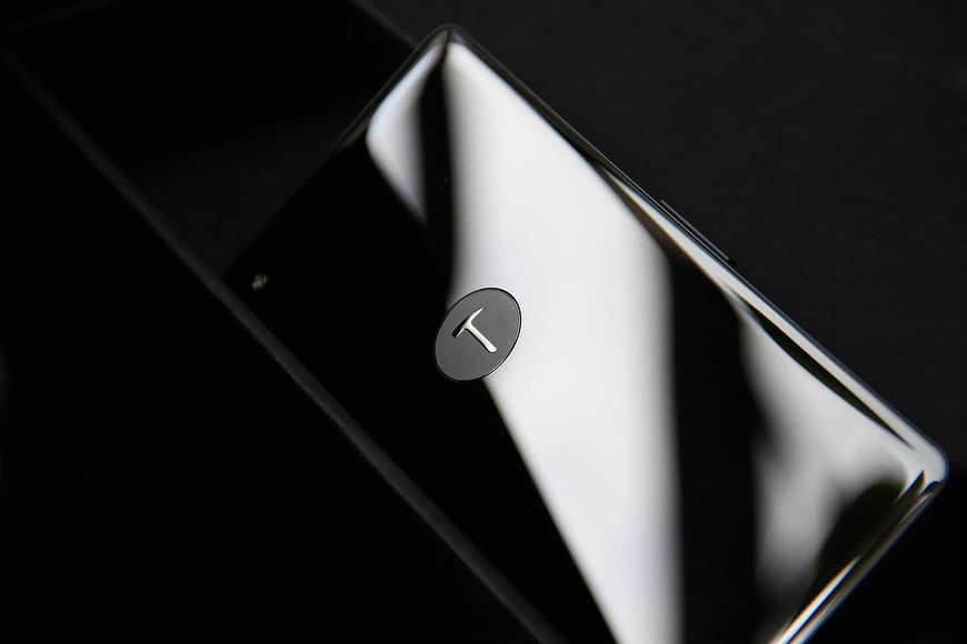 Close-up of sleek black smartphone with T logo