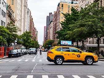 Yellow Taxi and Cyclist on Manhattan Street