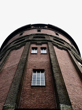 Low angle view of red brick water tower architecture