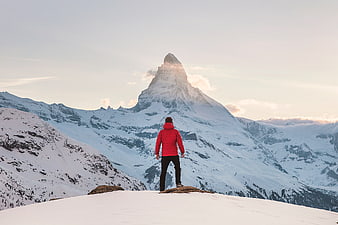 Man in Red Jacket Viewing Matterhorn Mountain in Winter