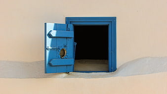Open Blue Wooden Door on Beige Wall