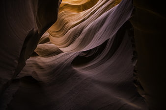 Abstract sandstone waves in slot canyon with dramatic lighting
