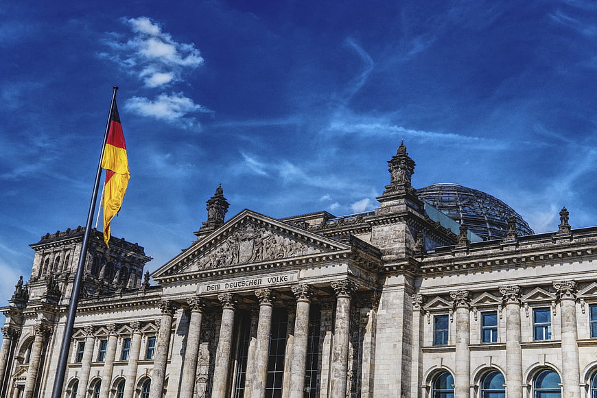 Reichstag Building Berlin with German Flag and Glass Dome