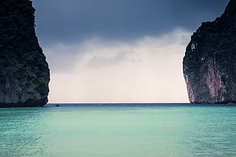 Dramatic tropical sea view between towering limestone cliffs