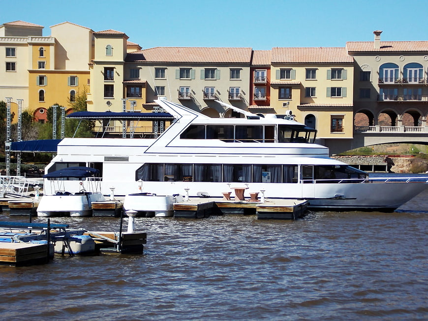 White Luxury Yacht Docked at Marina with Mediterranean Buildings