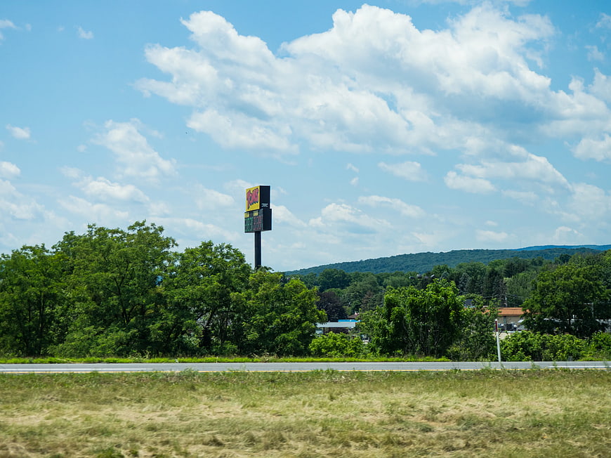 Roadside Landscape with Gas Station Sign and Blue Sky