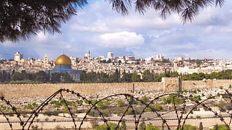 Jerusalem skyline with Dome of the Rock and barbed wire foreground