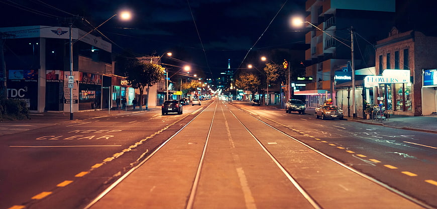 Night City Street with Tram Tracks and Streetlights