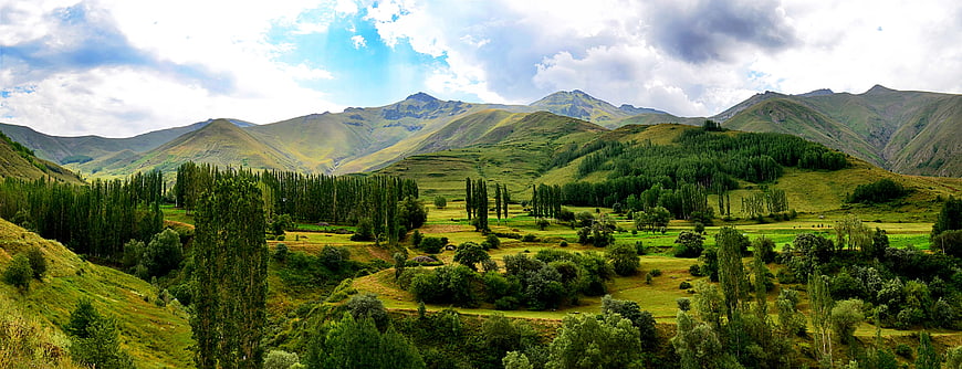 Panoramic Green Mountain Landscape with Cloudy Sky