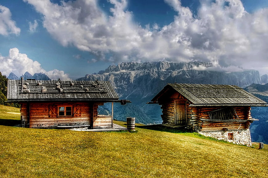 Rustic Alpine Cabins on Grassy Mountain Slope