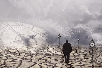 Silhouette of elderly man walking on cracked earth with clocks