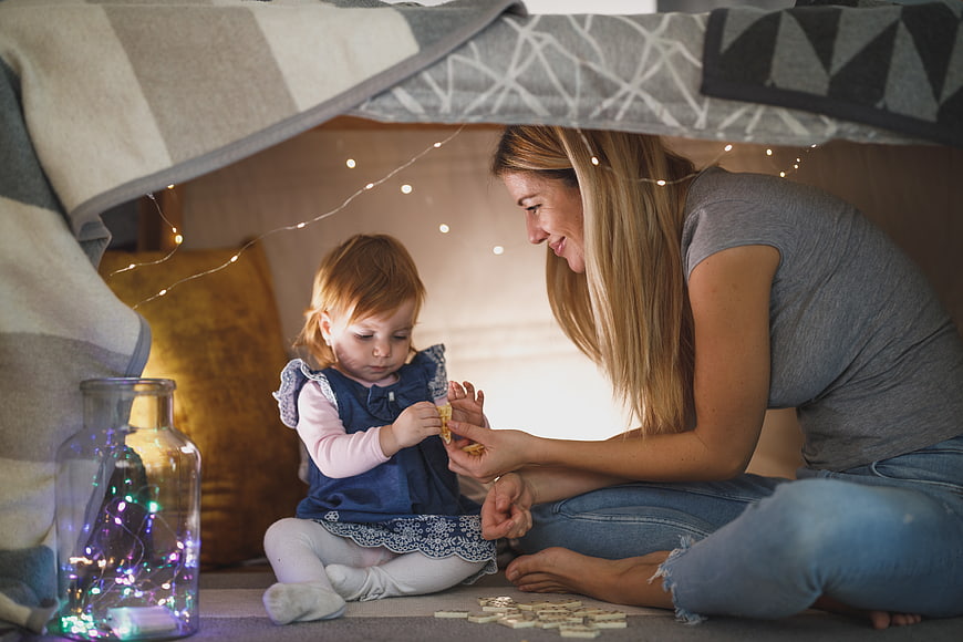 Mother and Toddler Playing in Cozy Blanket Fort