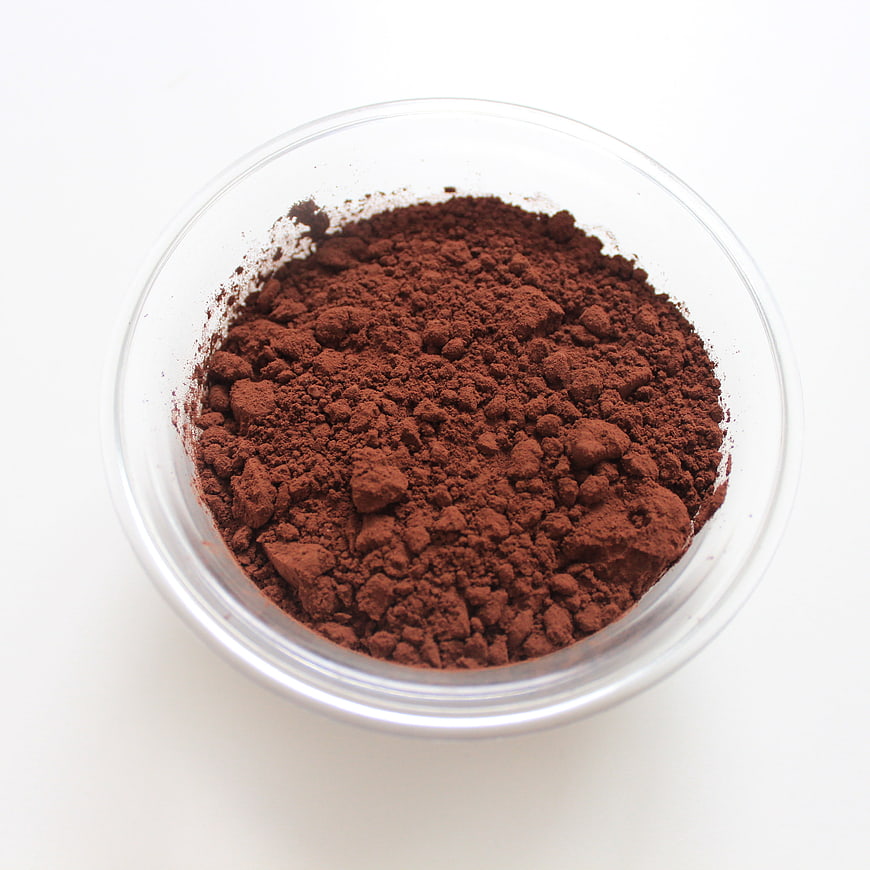 Cocoa Powder In Clear Glass Bowl On White Background