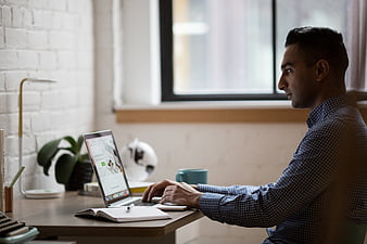 Man working on laptop in modern home office
