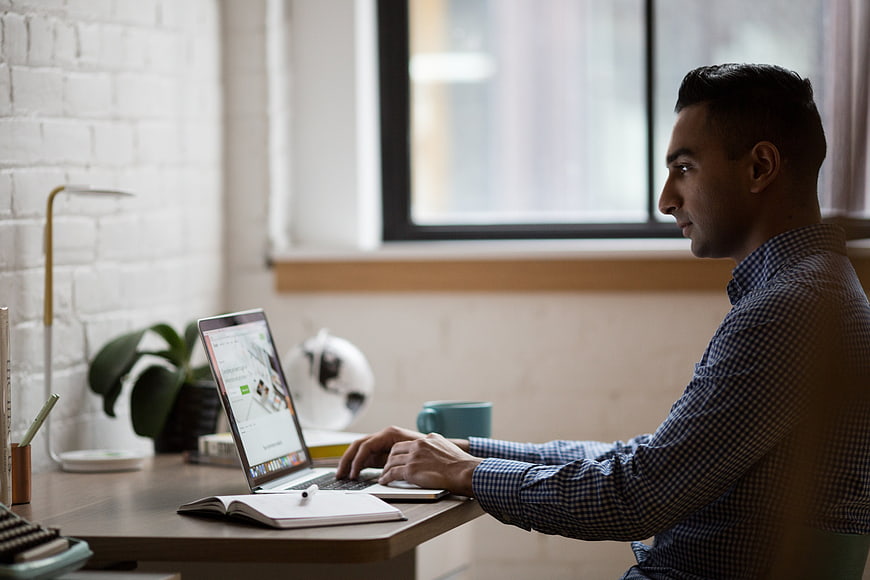 Man working on laptop in modern home office