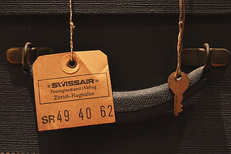Vintage Swissair Luggage Tag and Key on Suitcase